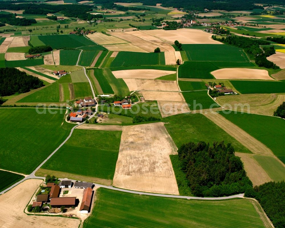 Holzham from above - Agricultural land and field boundaries surround the settlement area of the village in Holzham in the state Bavaria, Germany