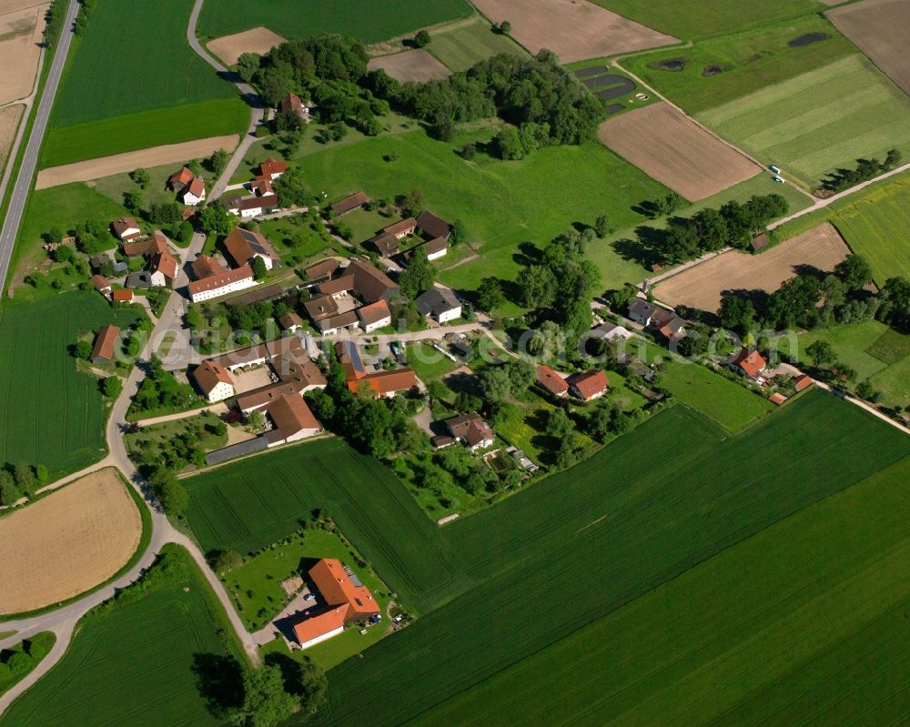 Holzham from above - Agricultural land and field boundaries surround the settlement area of the village in Holzham in the state Bavaria, Germany