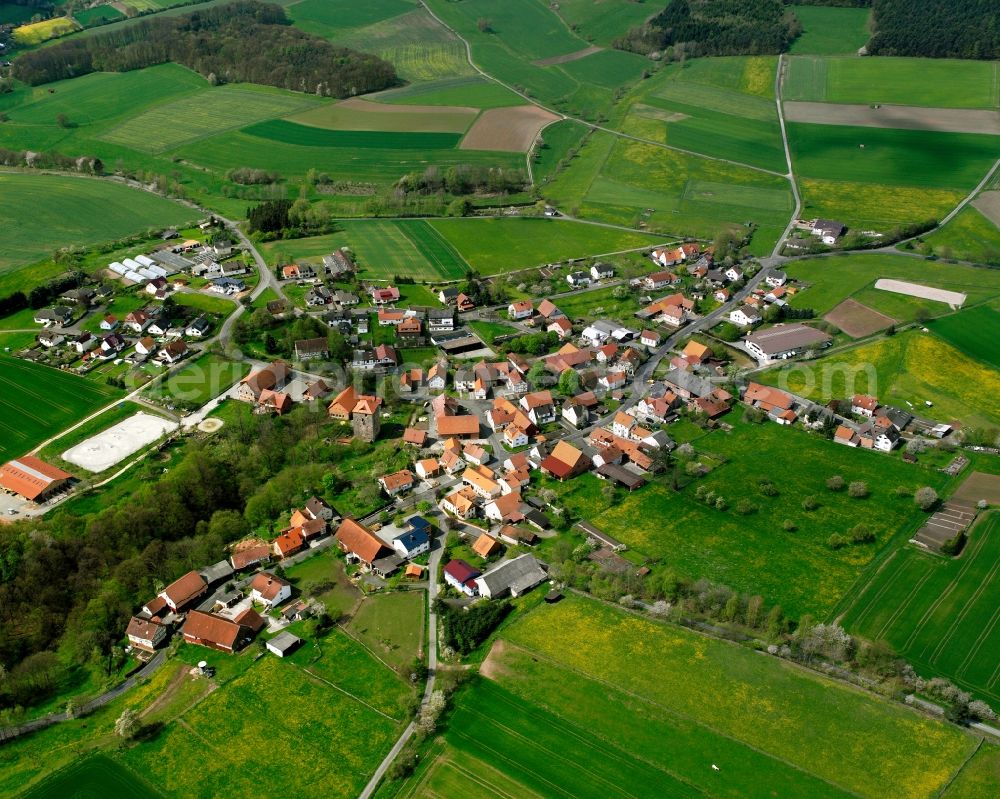 Aerial image Holzheim - Agricultural land and field boundaries surround the settlement area of the village in Holzheim in the state Hesse, Germany