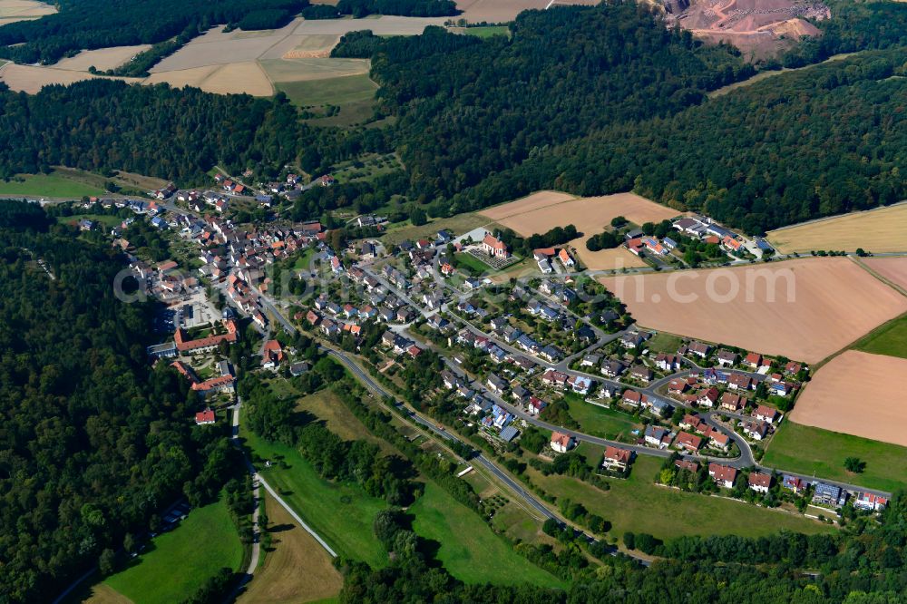 Holzkirchen from the bird's eye view: Agricultural land and field boundaries surround the settlement area of the village in Holzkirchen in the state Bavaria, Germany