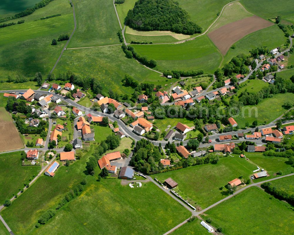 Aerial image Holzmühl - Agricultural land and field boundaries surround the settlement area of the village in Holzmühl in the state Hesse, Germany