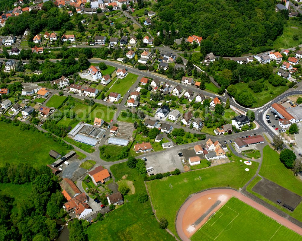 Aerial photograph Homberg (Ohm) - Agricultural land and field boundaries surround the settlement area of the village in Homberg (Ohm) in the state Hesse, Germany