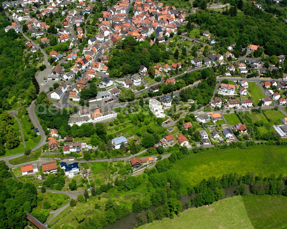 Homberg (Ohm) from above - Agricultural land and field boundaries surround the settlement area of the village in Homberg (Ohm) in the state Hesse, Germany