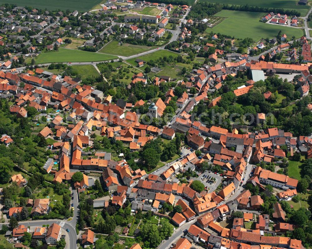 Hornburg from above - Agricultural land and field boundaries surround the settlement area of the village in Hornburg in the state Lower Saxony, Germany