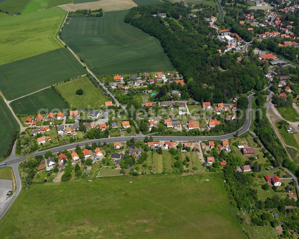 Hornburg from above - Agricultural land and field boundaries surround the settlement area of the village in Hornburg in the state Lower Saxony, Germany