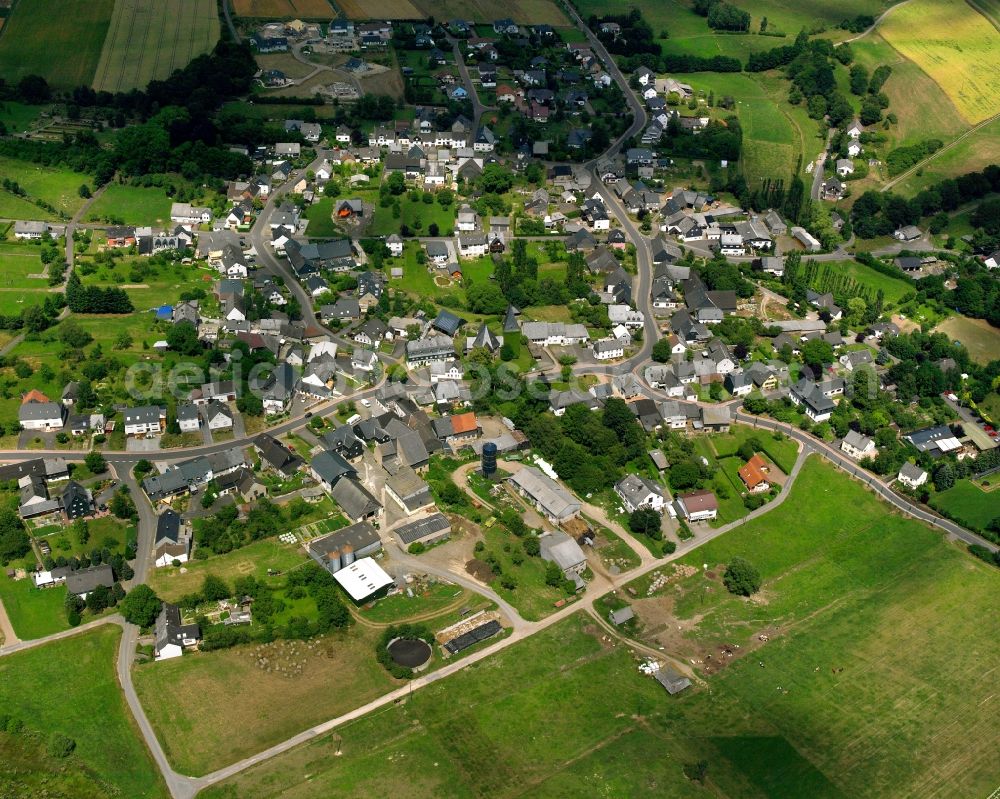 Aerial image Hottenbach - Agricultural land and field boundaries surround the settlement area of the village in Hottenbach in the state Rhineland-Palatinate, Germany