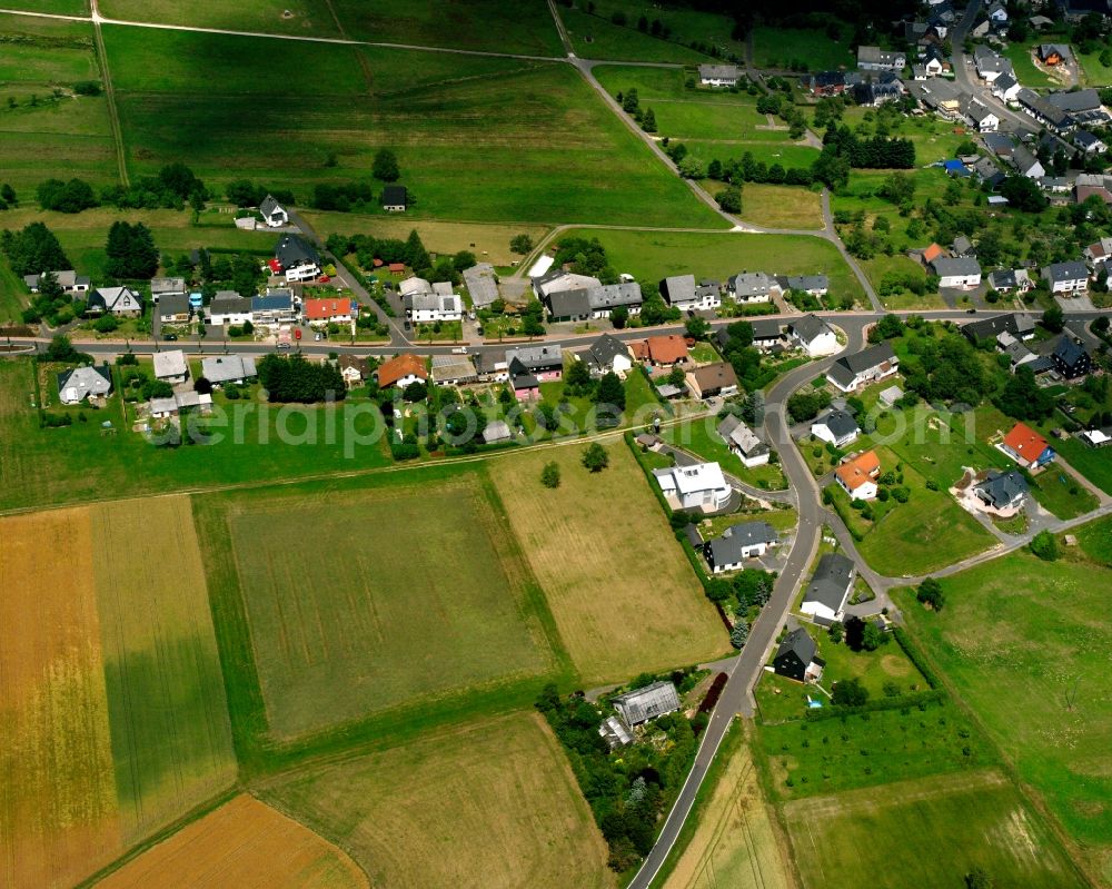 Aerial photograph Hottenbach - Agricultural land and field boundaries surround the settlement area of the village in Hottenbach in the state Rhineland-Palatinate, Germany