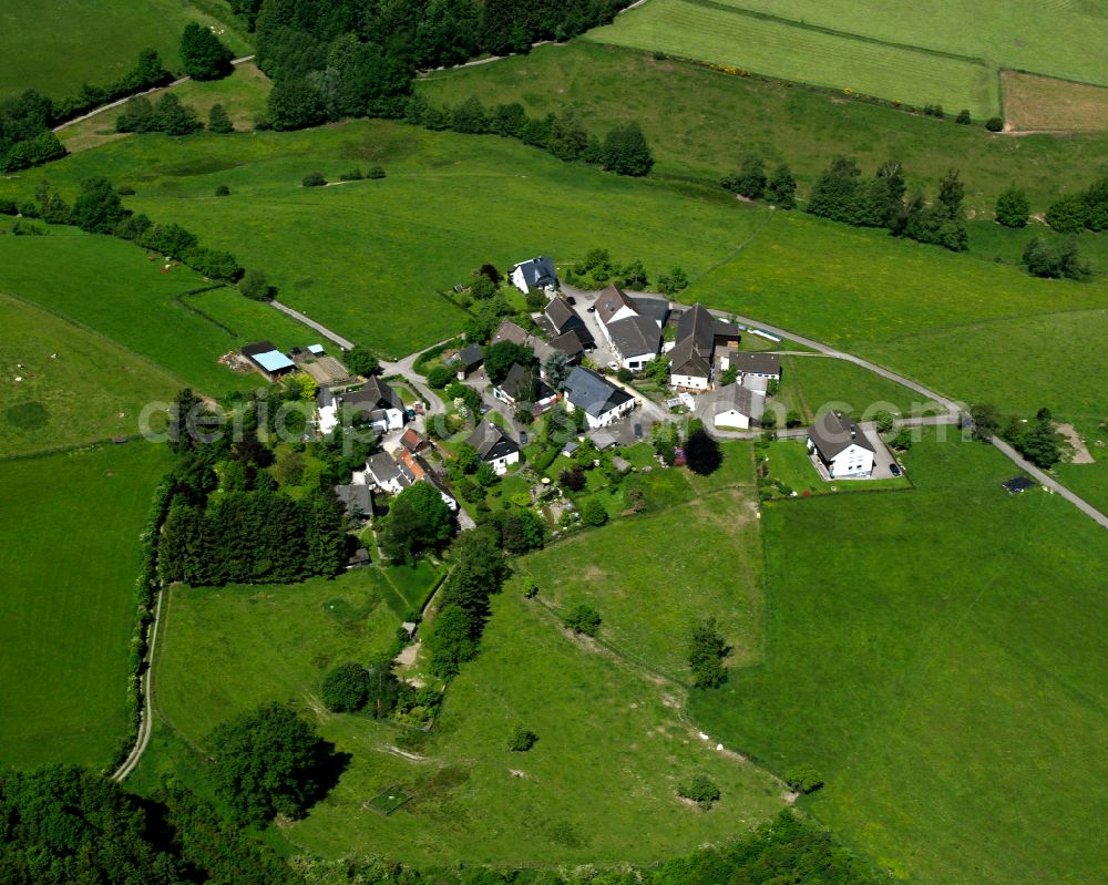 Aerial photograph Hüttebruch - Agricultural land and field boundaries surround the settlement area of the village in Hüttebruch in the state North Rhine-Westphalia, Germany