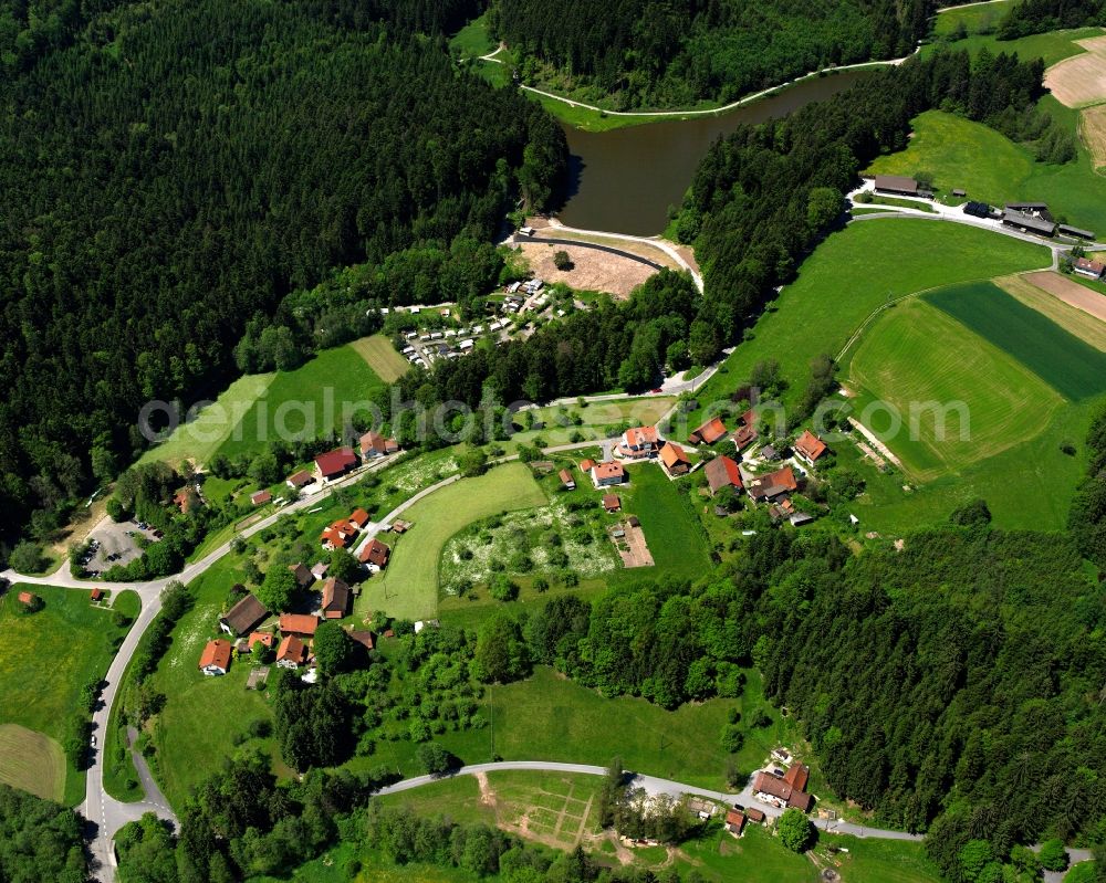 Aerial photograph Hüttenbühl - Agricultural land and field boundaries surround the settlement area of the village in Hüttenbühl in the state Baden-Wuerttemberg, Germany