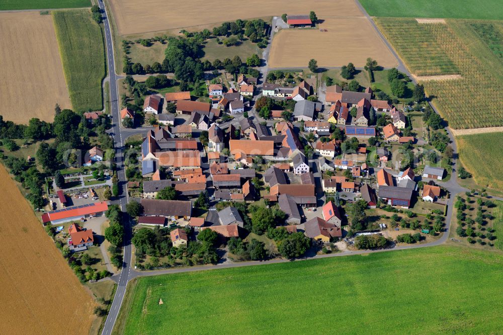 Höttingen from above - Agricultural land and field boundaries surround the settlement area of the village in Höttingen in the state Bavaria, Germany