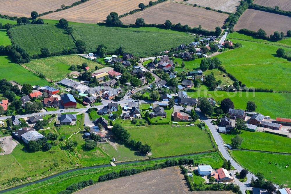 Aerial photograph Hummelfeld - Agricultural land and field boundaries surround the settlement area of the village in Hummelfeld in the state Schleswig-Holstein, Germany