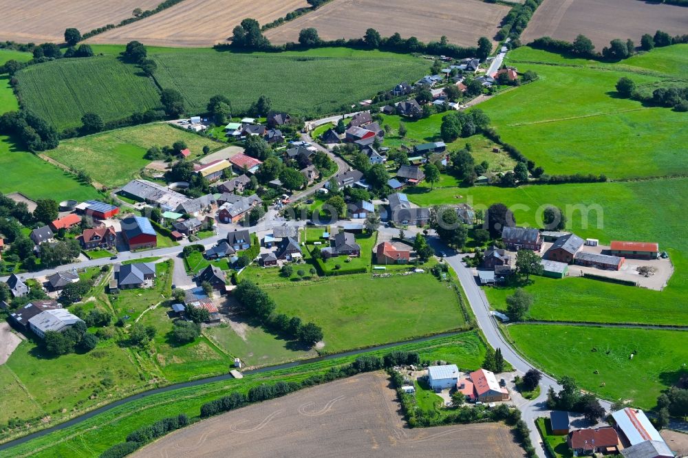 Hummelfeld from above - Agricultural land and field boundaries surround the settlement area of the village in Hummelfeld in the state Schleswig-Holstein, Germany