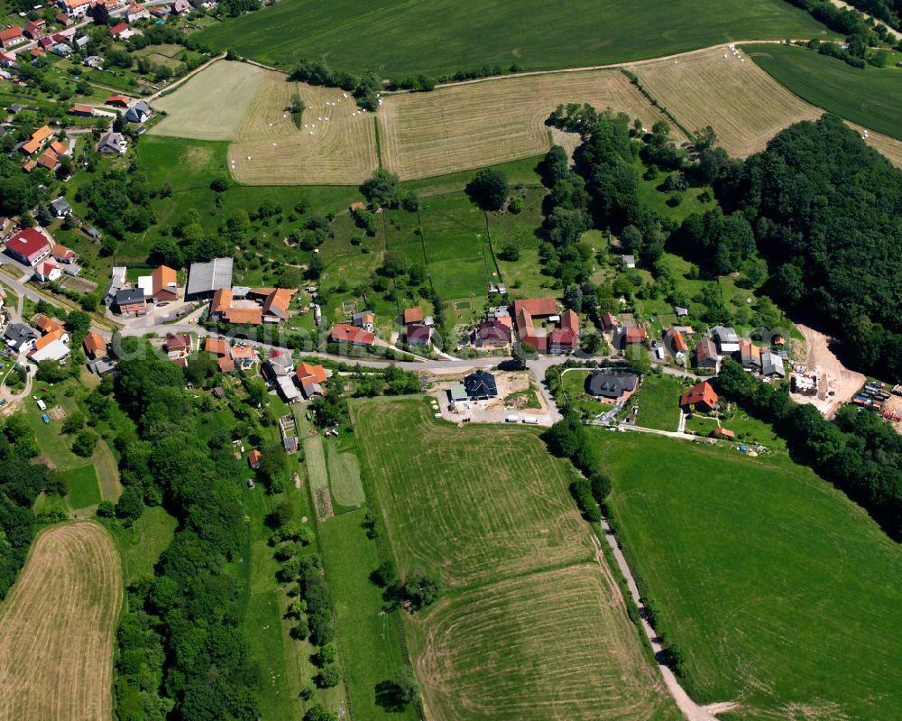 Aerial image Hundeshagen - Agricultural land and field boundaries surround the settlement area of the village in Hundeshagen in the state Thuringia, Germany