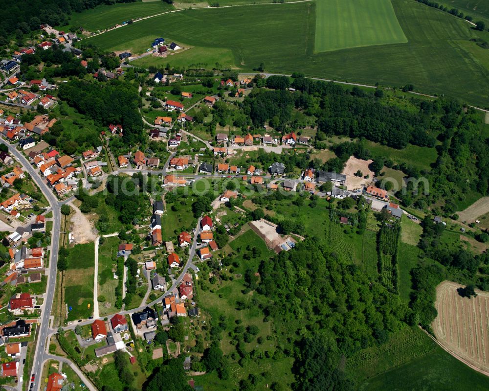 Hundeshagen from above - Agricultural land and field boundaries surround the settlement area of the village in Hundeshagen in the state Thuringia, Germany