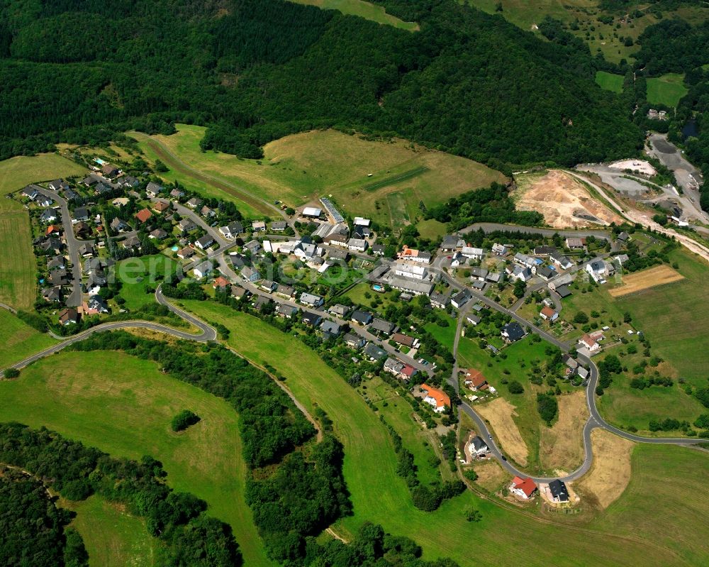 Idar from above - Agricultural land and field boundaries surround the settlement area of the village in Idar in the state Rhineland-Palatinate, Germany