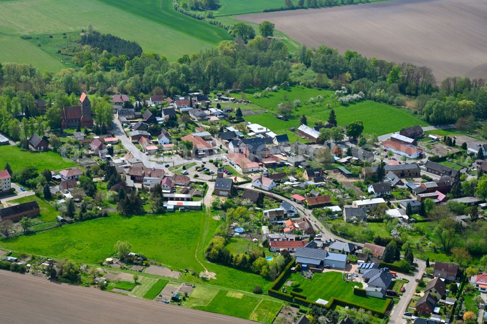 Iden from above - Agricultural land and field boundaries surround the settlement area of the village in Iden in the state Saxony-Anhalt, Germany