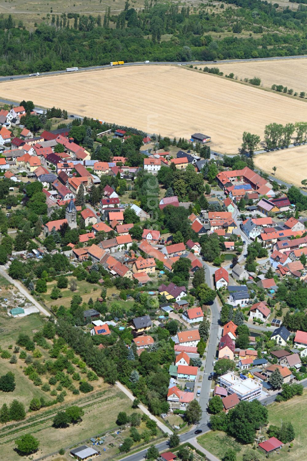 Aerial image Isseroda - Agricultural land and field boundaries surround the settlement area of the village in Isseroda in the state Thuringia, Germany