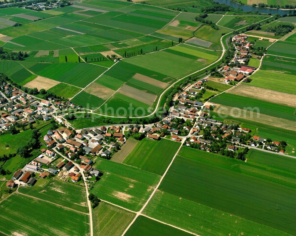 Ittling from the bird's eye view: Agricultural land and field boundaries surround the settlement area of the village in Ittling in the state Bavaria, Germany