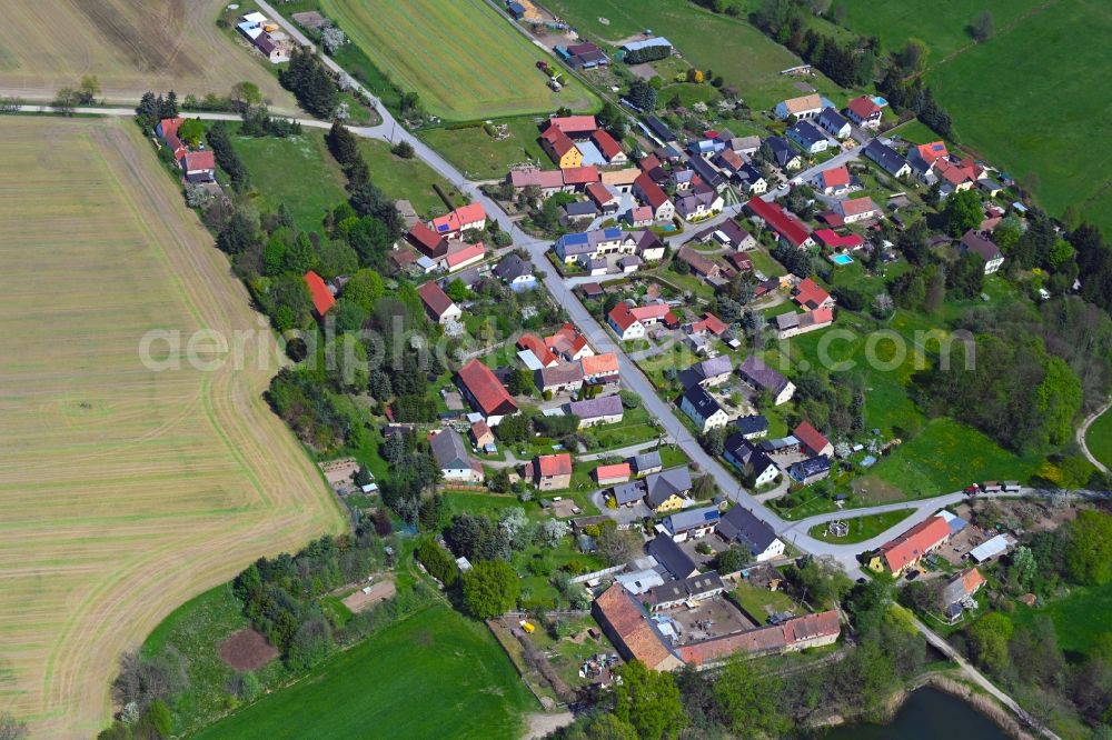 Jetscheba from above - Agricultural land and field boundaries surround the settlement area of the village along Heidestrasse in Jetscheba in the state Saxony, Germany