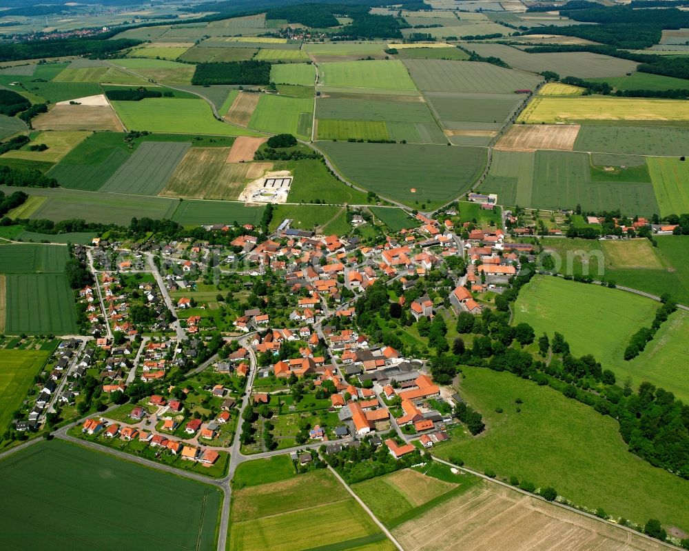 Jühnde from the bird's eye view: Agricultural land and field boundaries surround the settlement area of the village in Jühnde in the state Lower Saxony, Germany