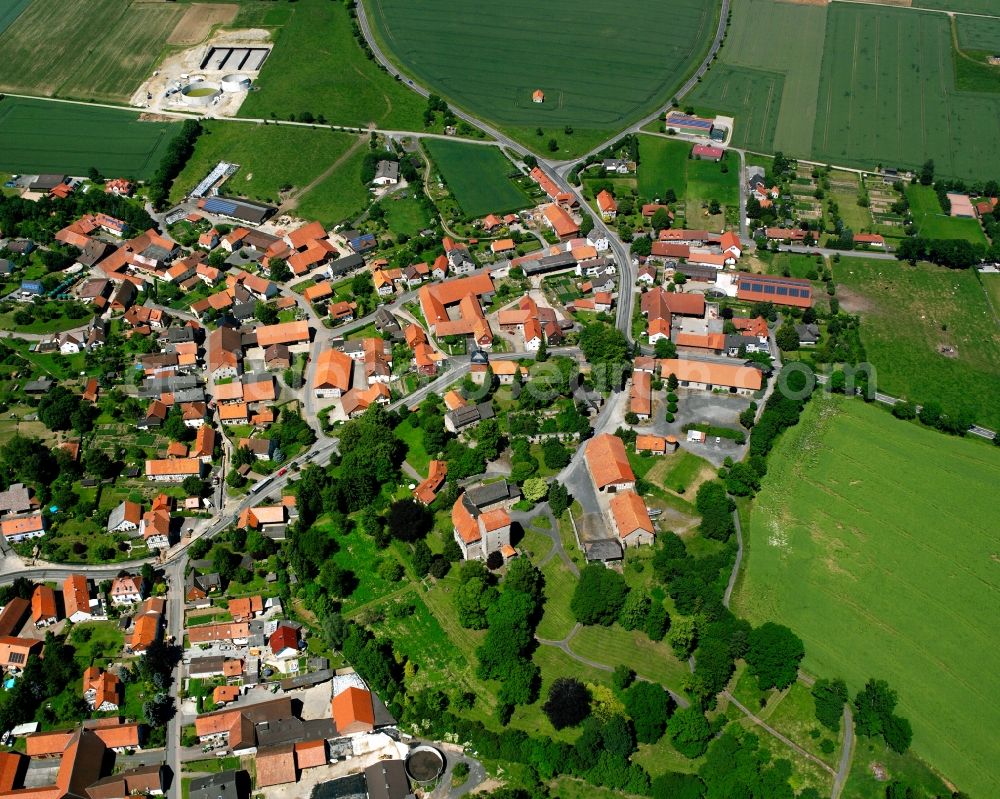 Aerial image Jühnde - Agricultural land and field boundaries surround the settlement area of the village in Jühnde in the state Lower Saxony, Germany