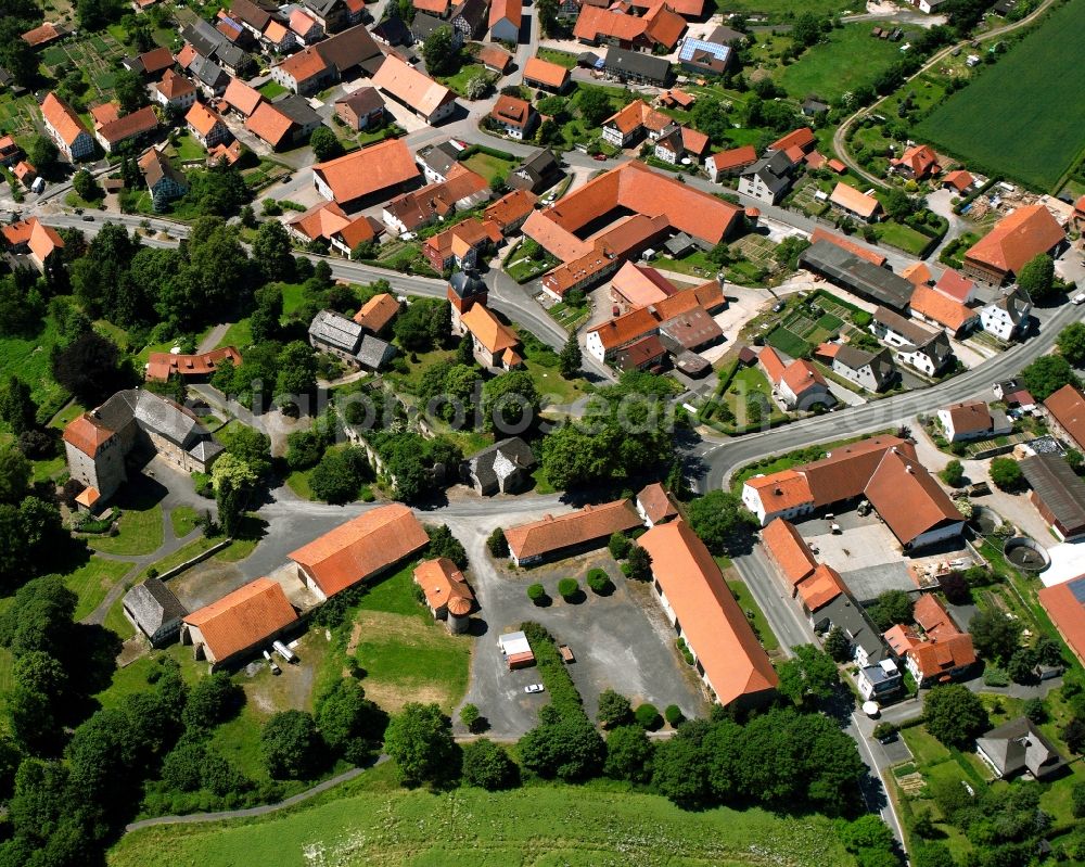 Jühnde from the bird's eye view: Agricultural land and field boundaries surround the settlement area of the village in Jühnde in the state Lower Saxony, Germany