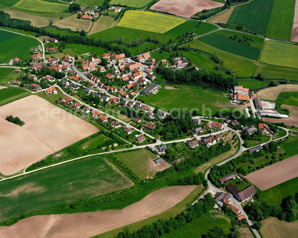 Jochsberg from the bird's eye view: Agricultural land and field boundaries surround the settlement area of the village in Jochsberg in the state Bavaria, Germany