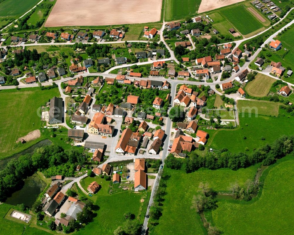 Aerial image Jochsberg - Agricultural land and field boundaries surround the settlement area of the village in Jochsberg in the state Bavaria, Germany