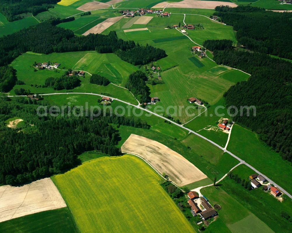 Johanniskirchen from above - Agricultural land and field boundaries surround the settlement area of the village in Johanniskirchen in the state Bavaria, Germany