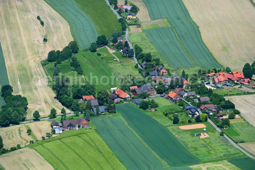 Kathrinhagen from the bird's eye view: Agricultural land and field boundaries surround the settlement area of the village in Kathrinhagen in the state Lower Saxony, Germany