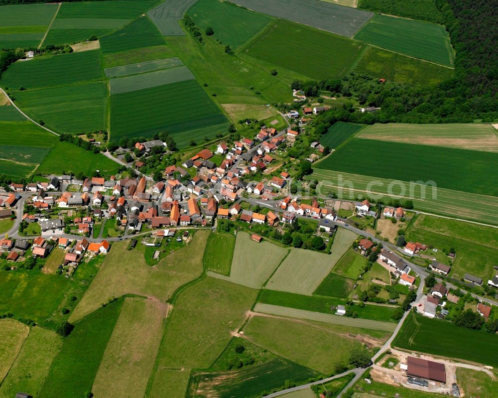 Kathus from above - Agricultural land and field boundaries surround the settlement area of the village in Kathus in the state Hesse, Germany