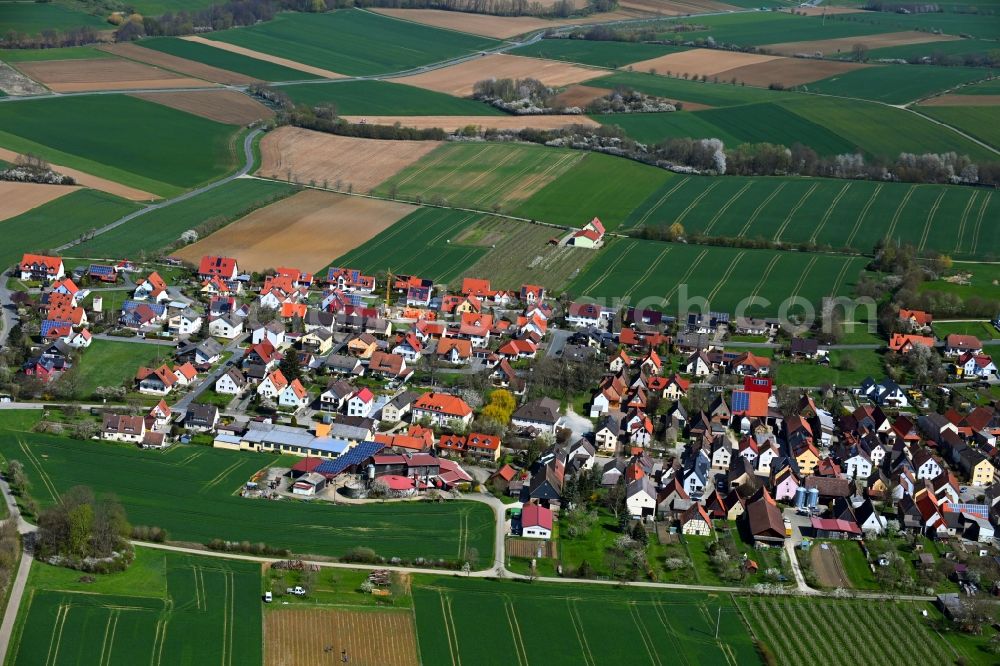 Kauernhofen from the bird's eye view: Agricultural land and field boundaries surround the settlement area of the village in Kauernhofen in the state Bavaria, Germany