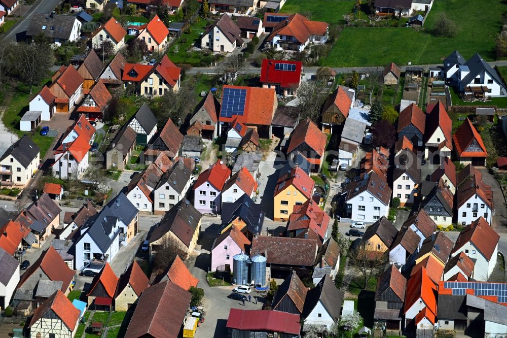 Kauernhofen from the bird's eye view: Agricultural land and field boundaries surround the settlement area of the village in Kauernhofen in the state Bavaria, Germany