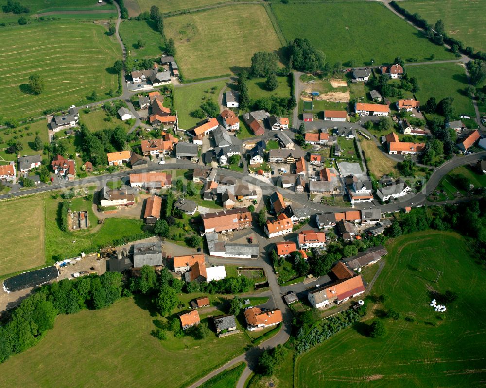 Kaulstoß from above - Agricultural land and field boundaries surround the settlement area of the village in Kaulstoß in the state Hesse, Germany