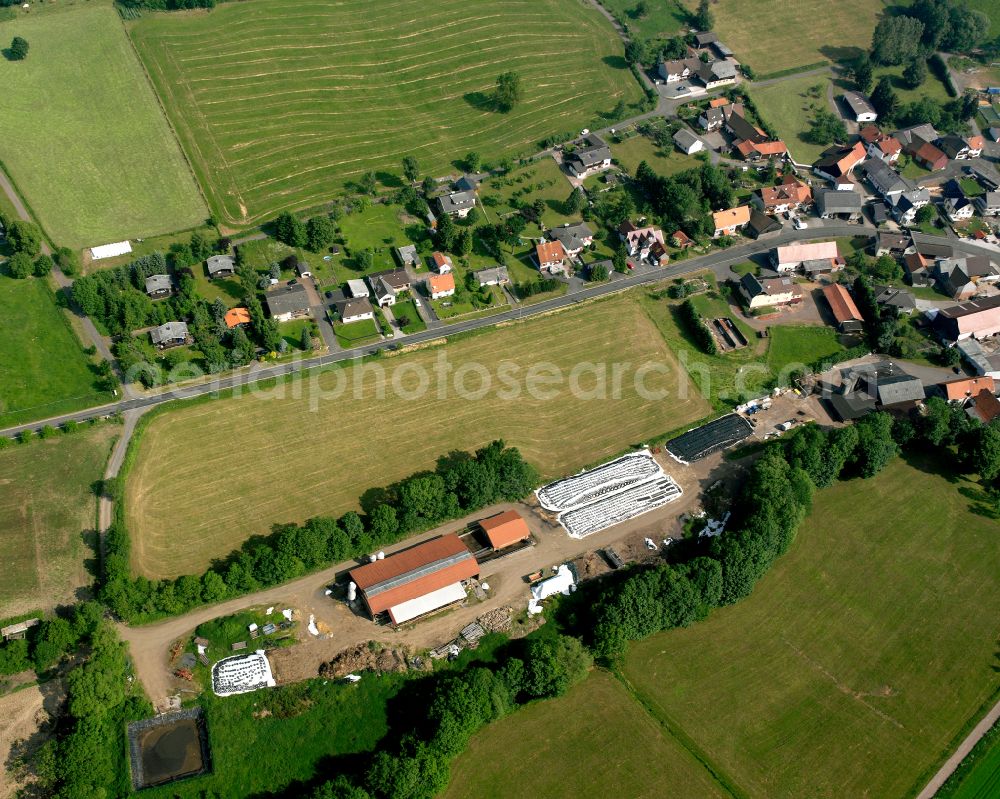 Kaulstoß from the bird's eye view: Agricultural land and field boundaries surround the settlement area of the village in Kaulstoß in the state Hesse, Germany