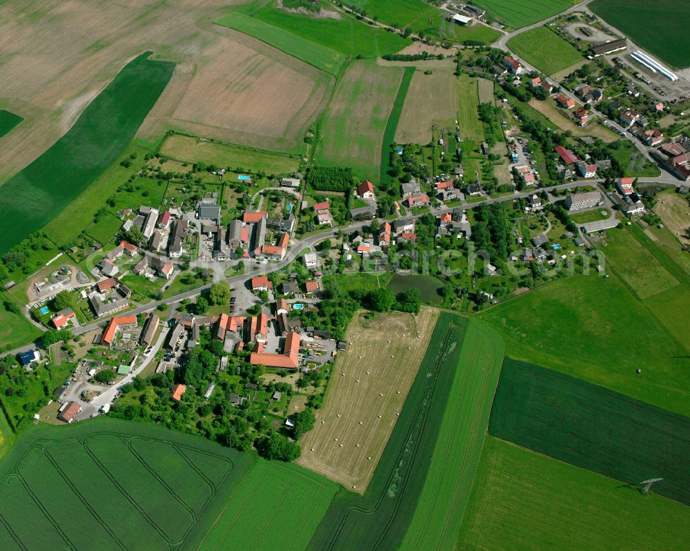 Köfeln from above - Agricultural land and field boundaries surround the settlement area of the village in Köfeln in the state Thuringia, Germany