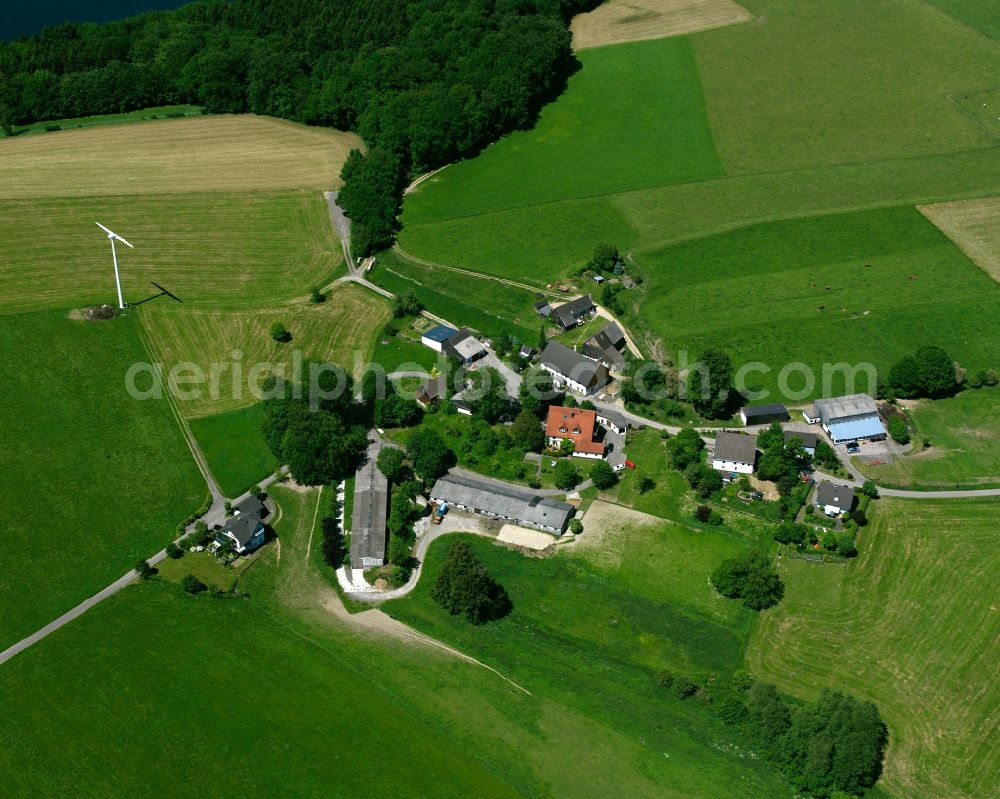 Kierspe from the bird's eye view: Agricultural land and field boundaries surround the settlement area of the village in Kierspe in the state North Rhine-Westphalia, Germany