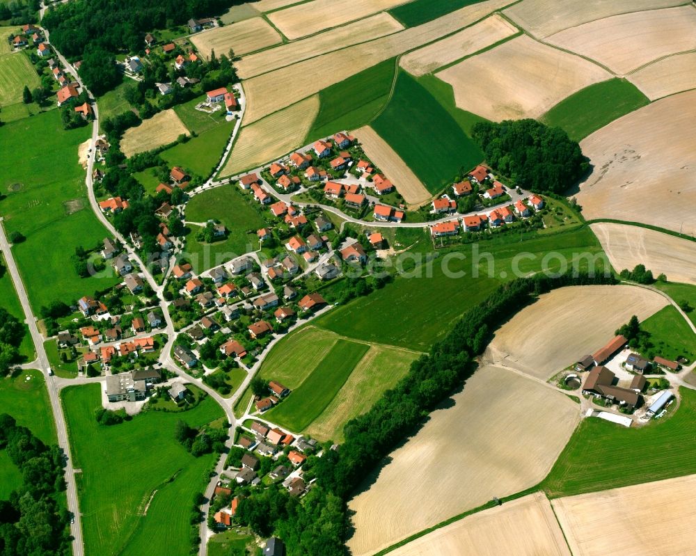 Kirchberg from above - Agricultural land and field boundaries surround the settlement area of the village in Kirchberg in the state Bavaria, Germany