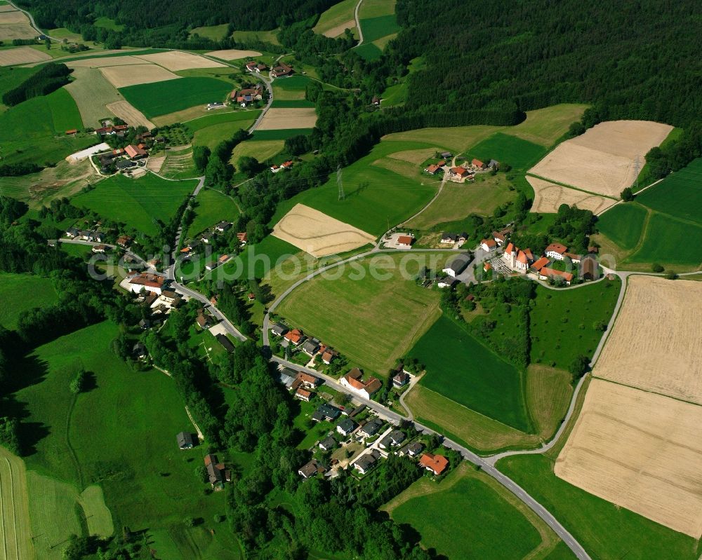 Kirchberg from above - Agricultural land and field boundaries surround the settlement area of the village in Kirchberg in the state Bavaria, Germany