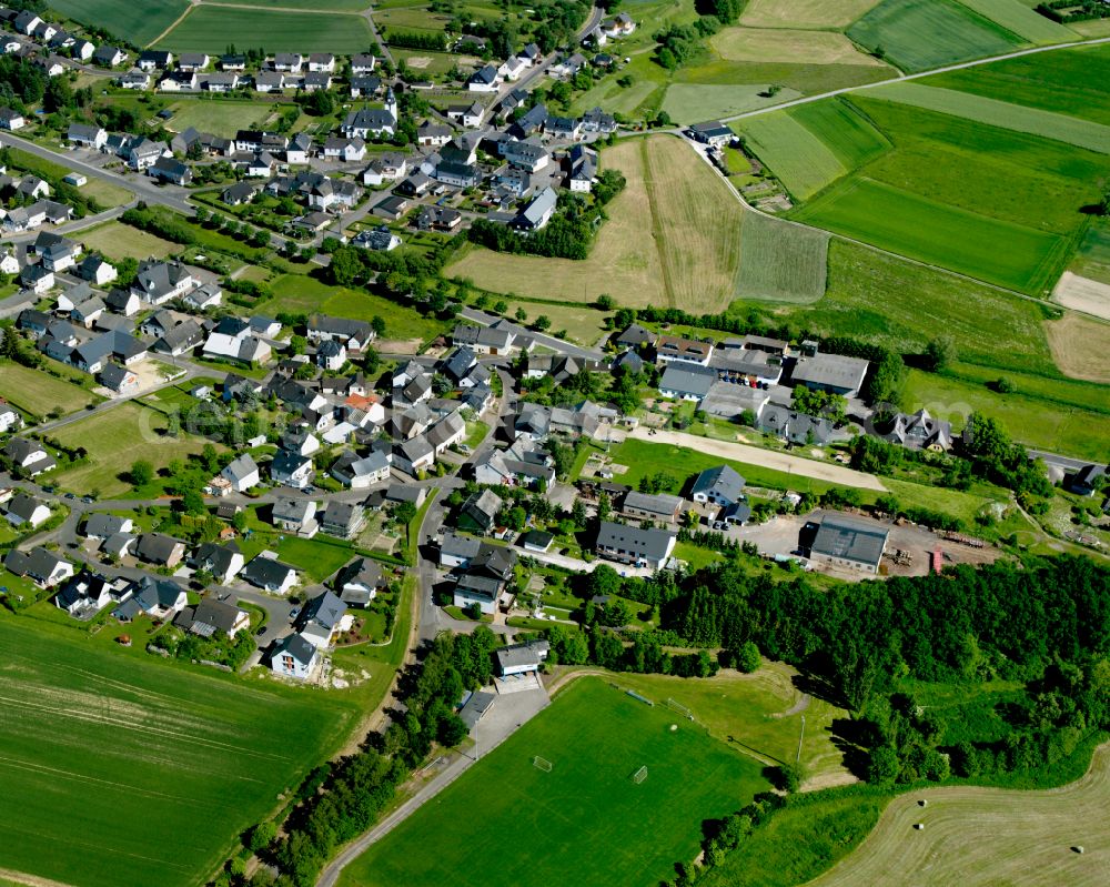 Aerial photograph Kisselbach - Agricultural land and field boundaries surround the settlement area of the village in Kisselbach in the state Rhineland-Palatinate, Germany