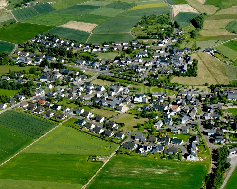 Kisselbach from above - Agricultural land and field boundaries surround the settlement area of the village in Kisselbach in the state Rhineland-Palatinate, Germany