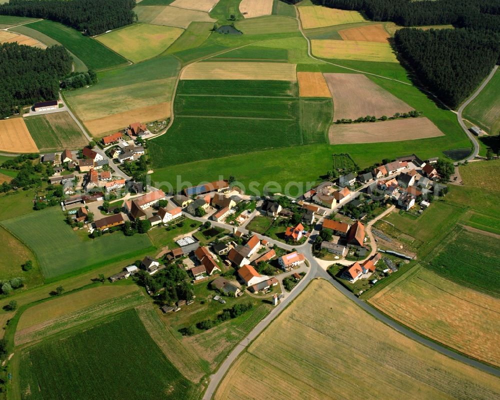 Kitschendorf from above - Agricultural land and field boundaries surround the settlement area of the village in Kitschendorf in the state Bavaria, Germany