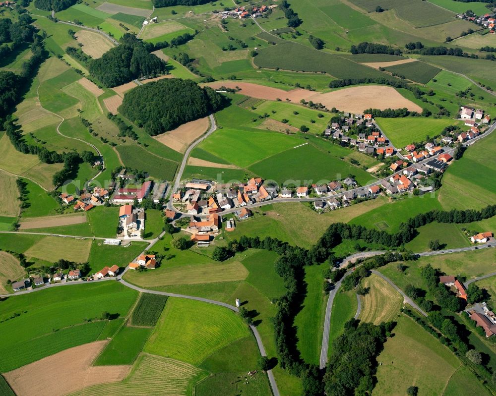 Klein-Gumpen from above - Agricultural land and field boundaries surround the settlement area of the village in Klein-Gumpen in the state Hesse, Germany