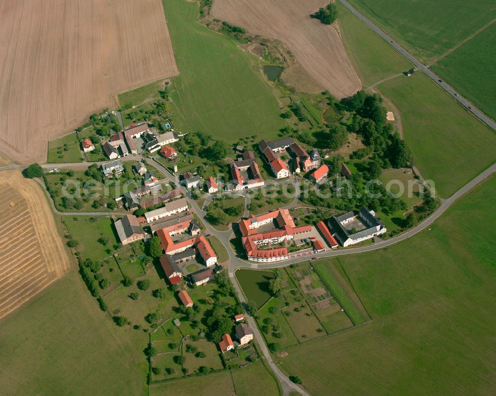 Kleindraxdorf from above - Agricultural land and field boundaries surround the settlement area of the village in Kleindraxdorf in the state Thuringia, Germany