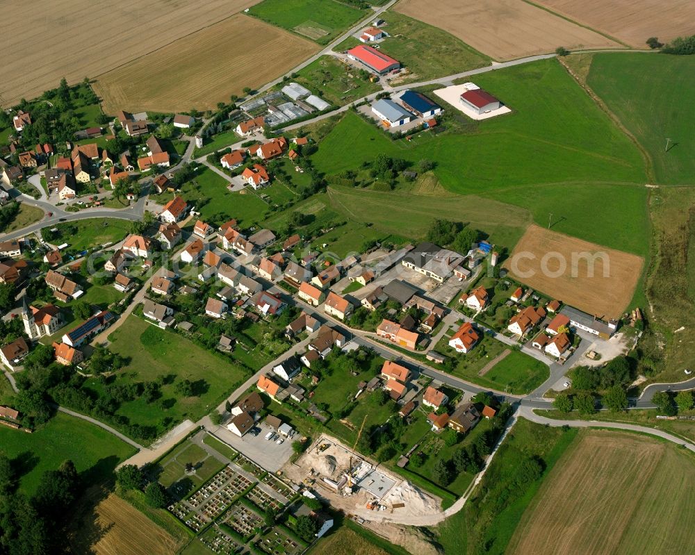 Kleinohrenbronn from above - Agricultural land and field boundaries surround the settlement area of the village in Kleinohrenbronn in the state Bavaria, Germany