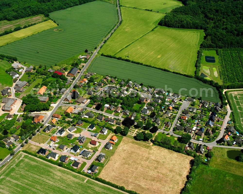 Kleinschretstaken from above - Agricultural land and field boundaries surround the settlement area of the village in Kleinschretstaken in the state Schleswig-Holstein, Germany