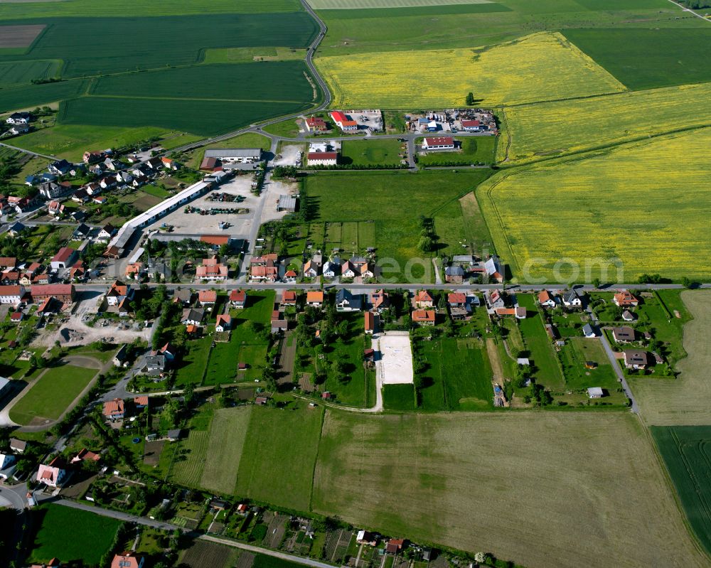 Küllstedt from above - Agricultural land and field boundaries surround the settlement area of the village in Küllstedt in the state Thuringia, Germany