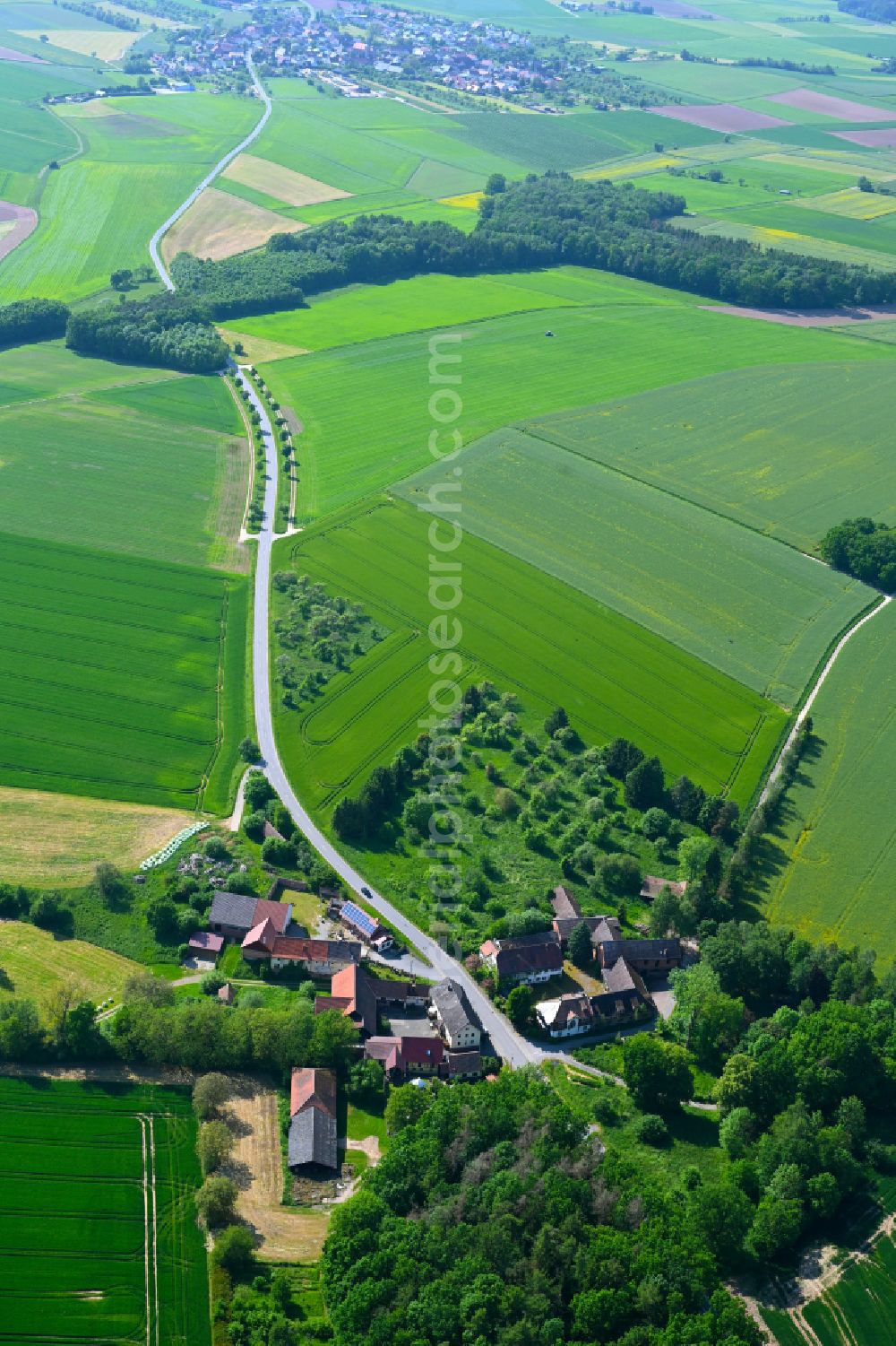 Külsheim from the bird's eye view: Agricultural land and field boundaries surround the settlement area of the village in Külsheim in the state Baden-Wuerttemberg, Germany