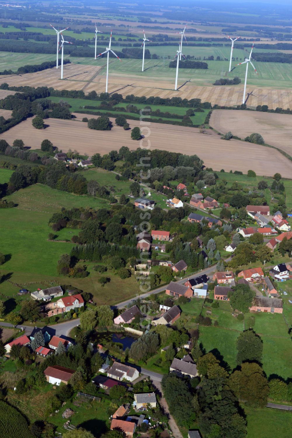 Kümmernitztal from above - Agricultural land and field boundaries surround the settlement area of the village on street Ringstrasse in Kuemmernitztal in the state Brandenburg, Germany