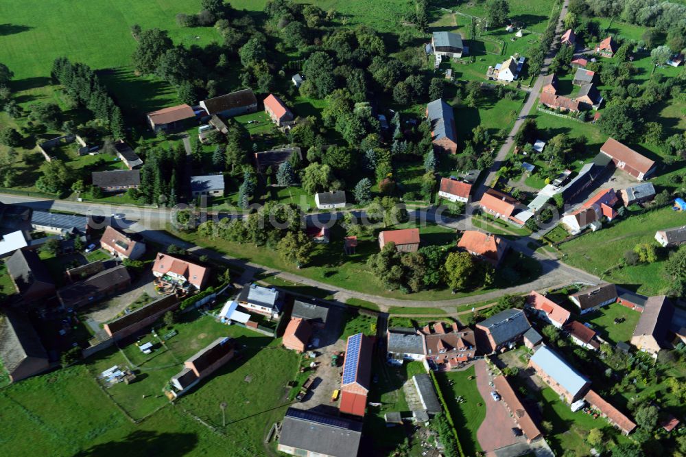 Aerial photograph Kümmernitztal - Agricultural land and field boundaries surround the settlement area of the village on street Ringstrasse in Kuemmernitztal in the state Brandenburg, Germany